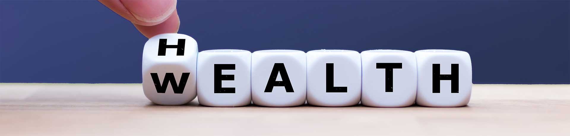 A row of dice that say Wealth with the first die angled to show a H for health too